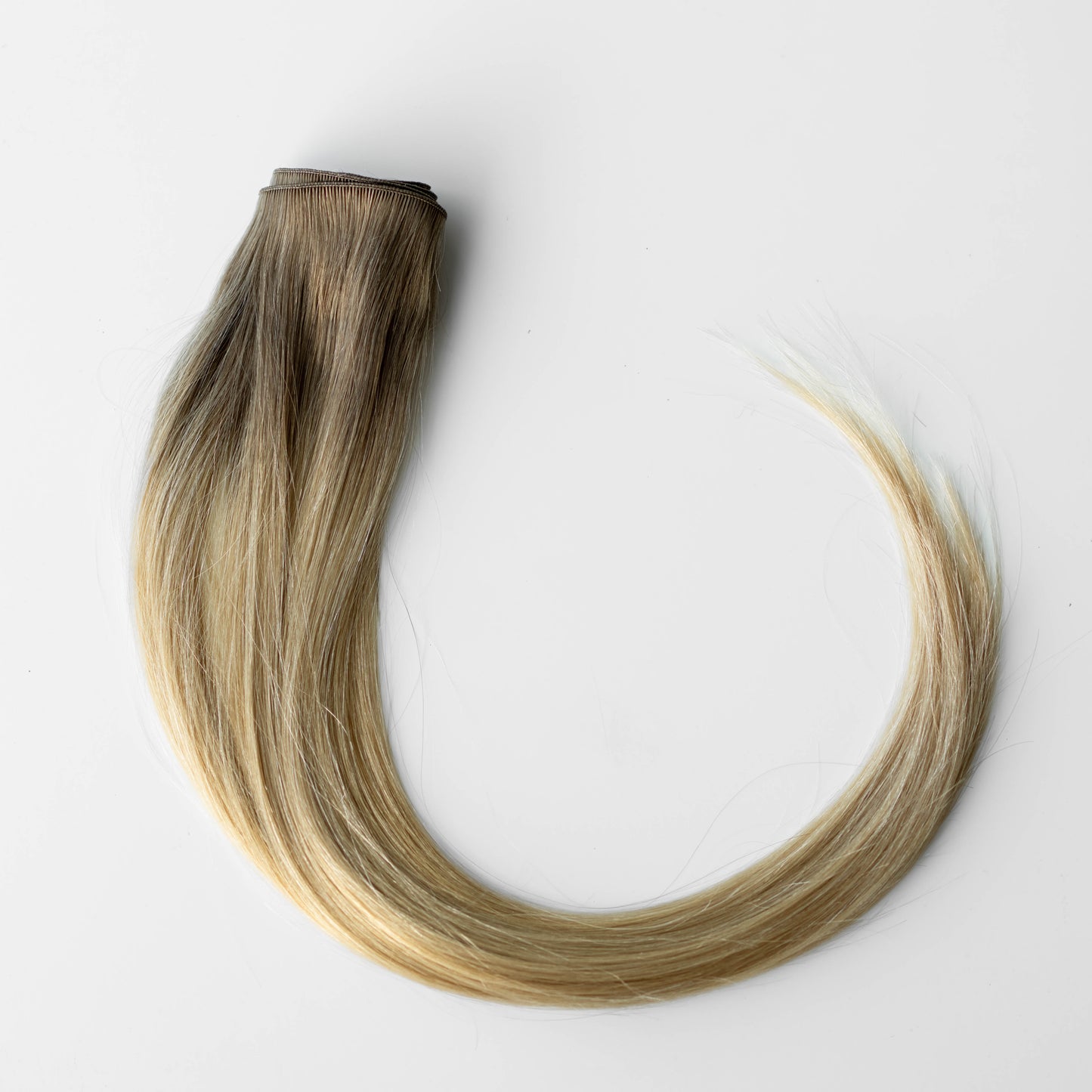 Blonde hair extensions on a white background