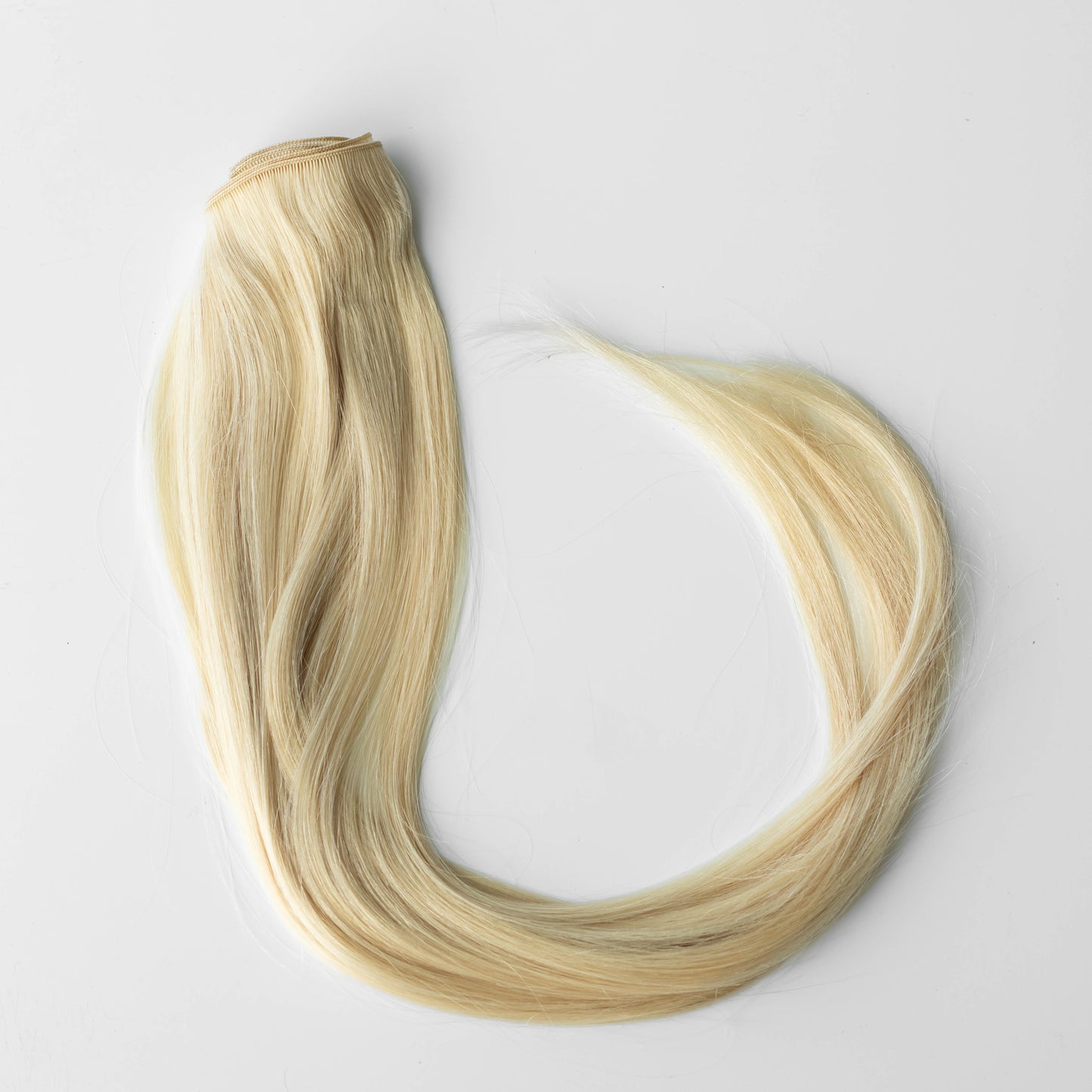Blonde hair extensions on a white background