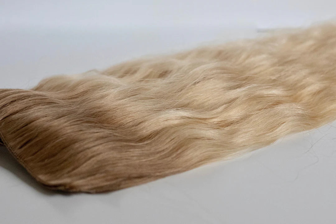 Blonde hair extensions on a white background