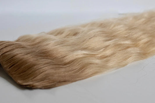 Blonde hair extensions on a white background