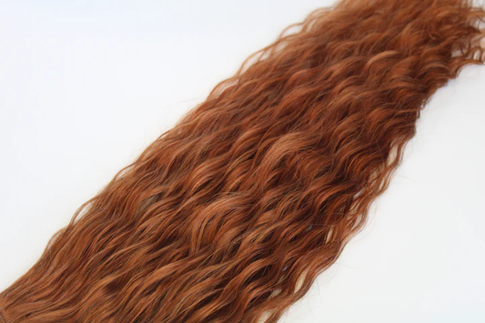 Curly red hair extensions on a white background