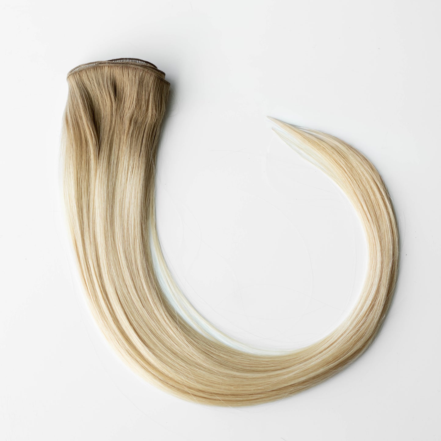 Blonde hair extensions on a white background