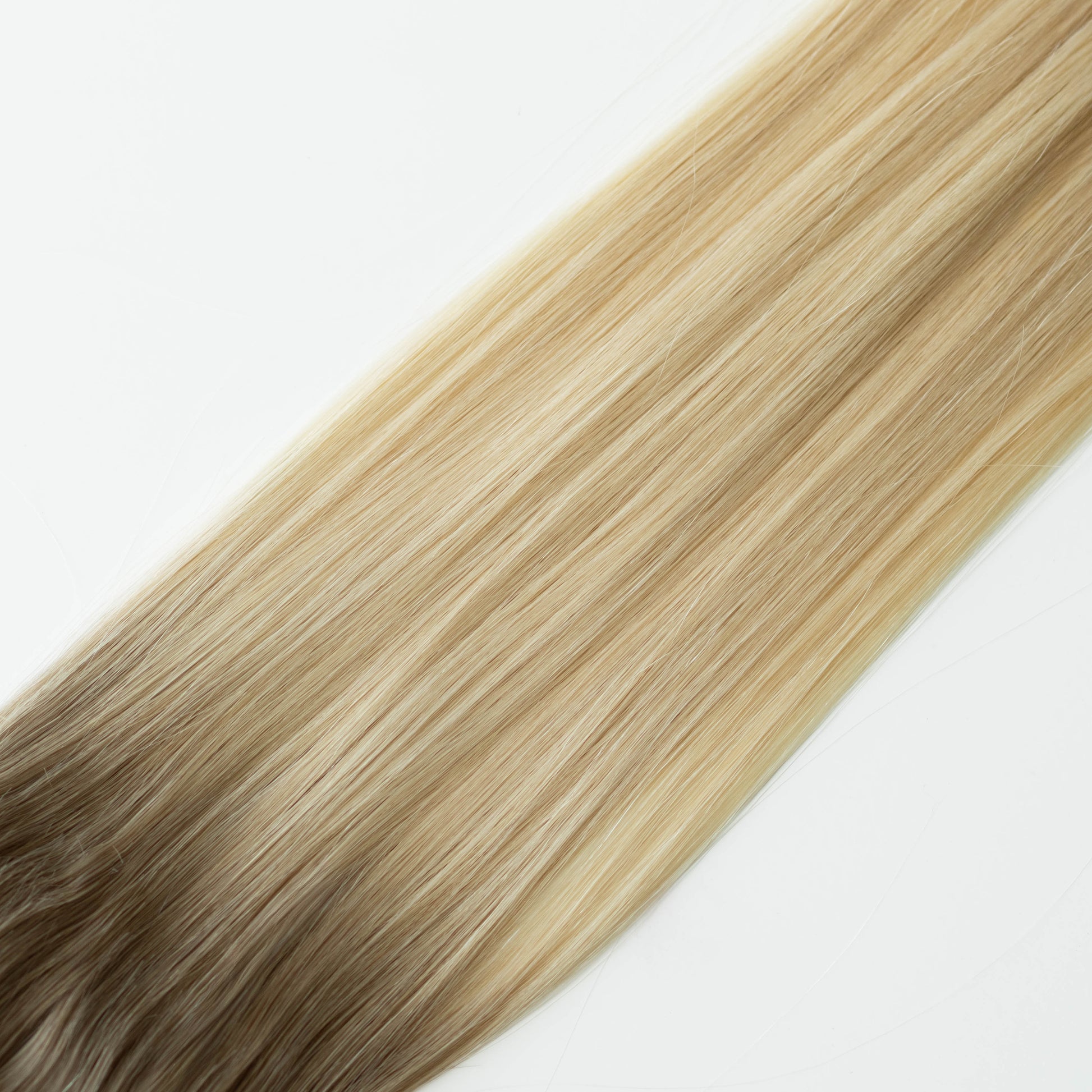 Blonde hair extensions on a white background