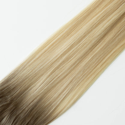 Blonde hair extensions on a white background