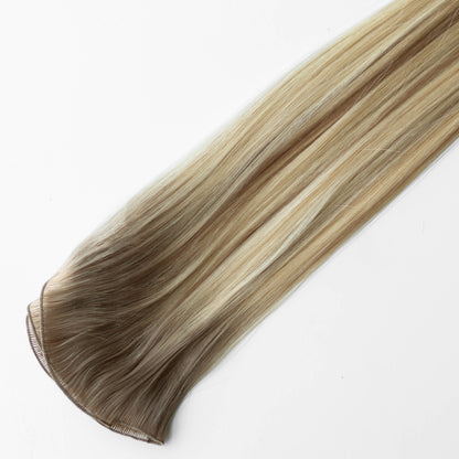 Blonde hair extension on a white background