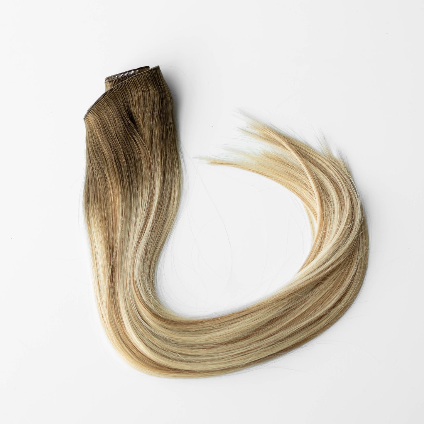Blonde hair extensions on a white background