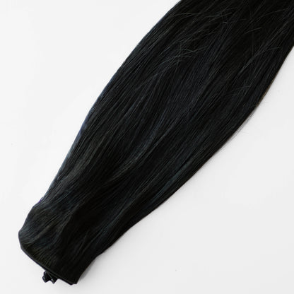 Black hair extension on a white background