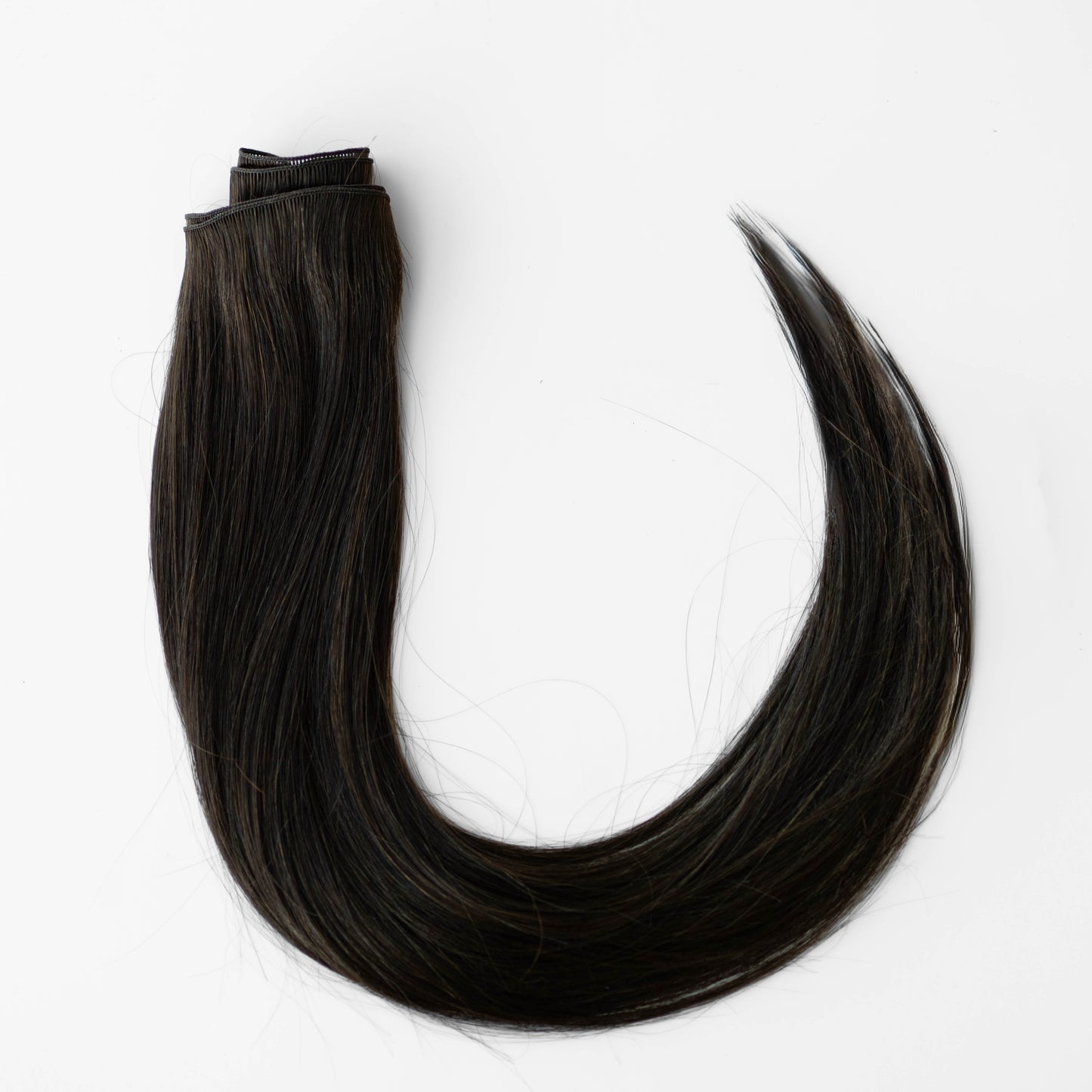 Dark brown hair extensions on a white background