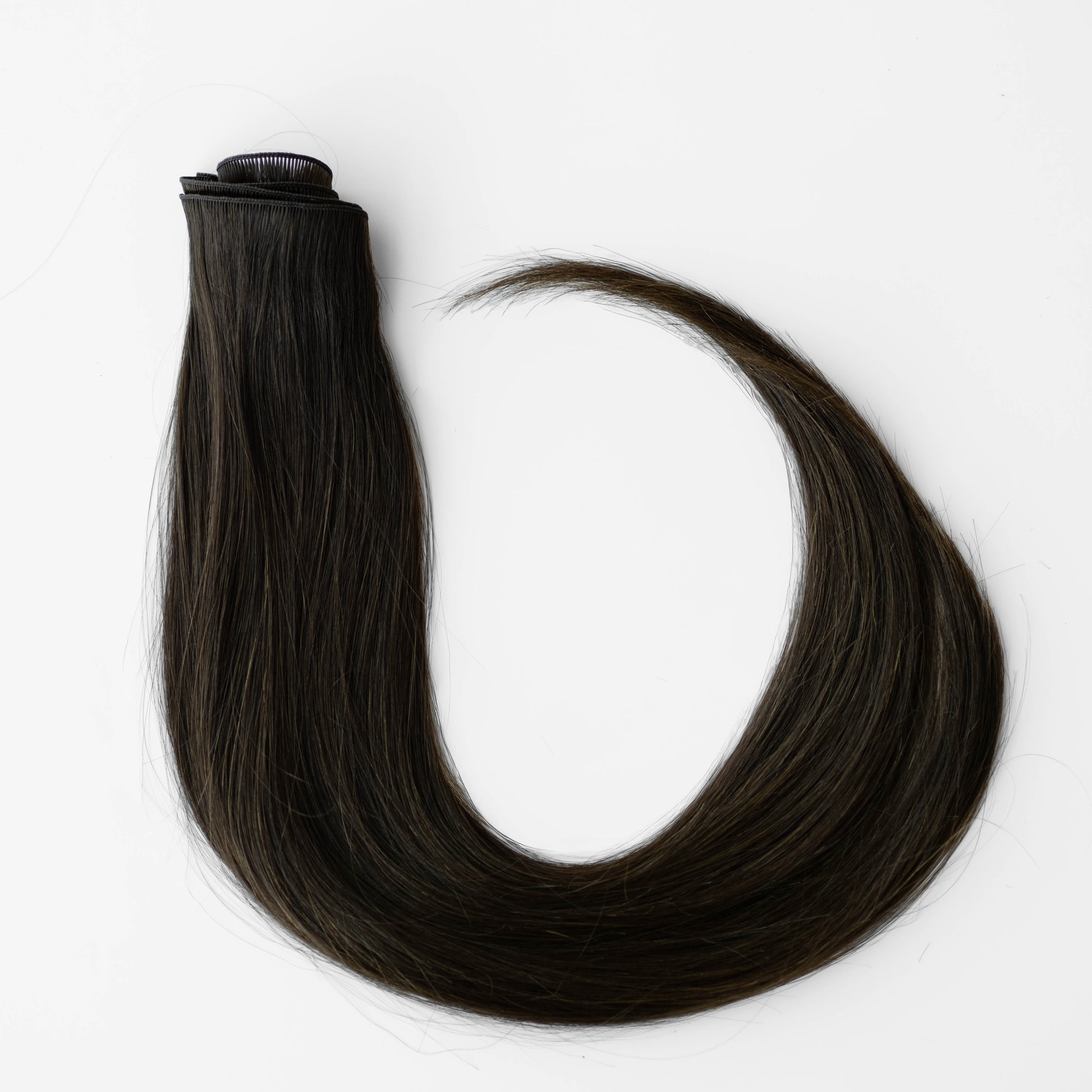 Dark brown hair extensions on a white background