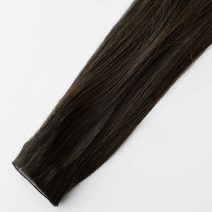 Dark brown hair extension on a white background