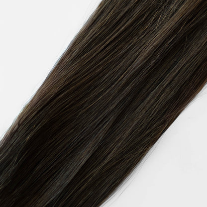 Dark brown hair extensions on a white background
