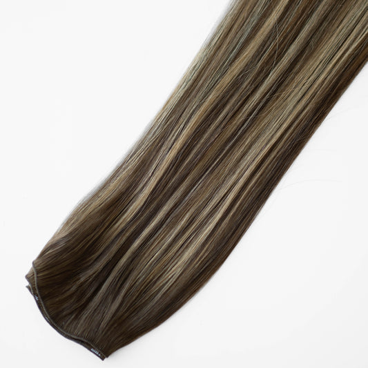 Brown and blonde hair extension on a white background