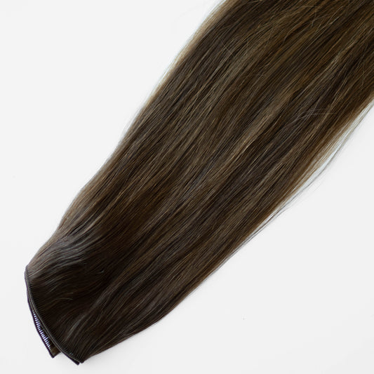 Brown hair extension on a white background