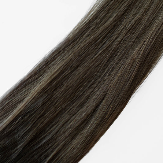 Dark brown hair extensions on a white background