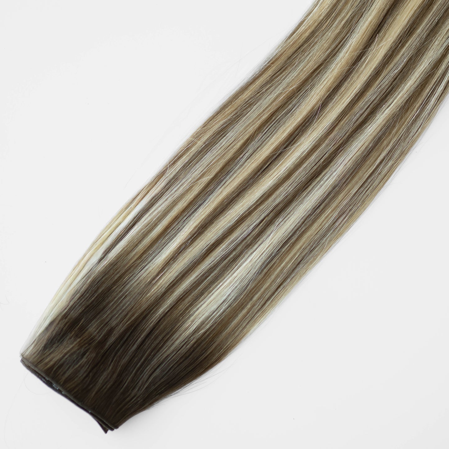 Hair extension with brown and blonde color gradient on a white background