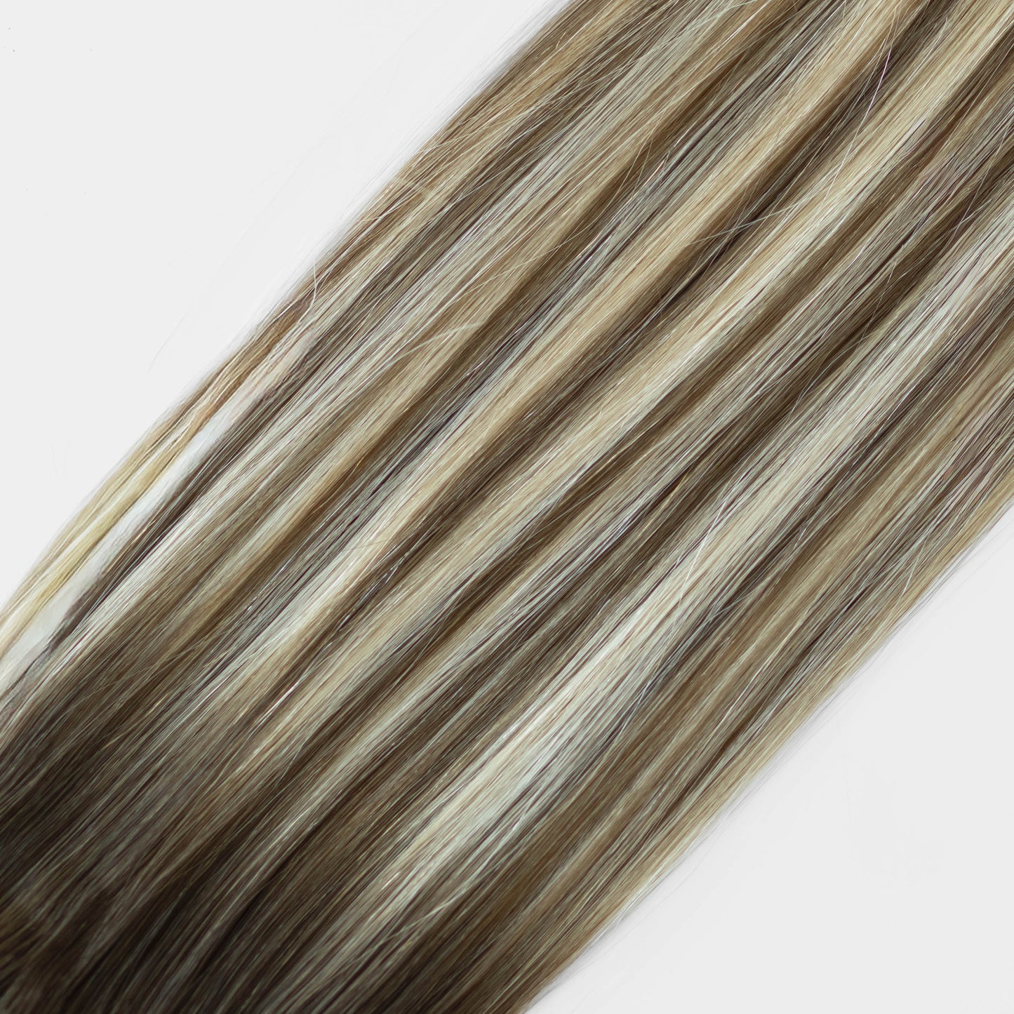 Hair extensions with brown and blonde color on a white background