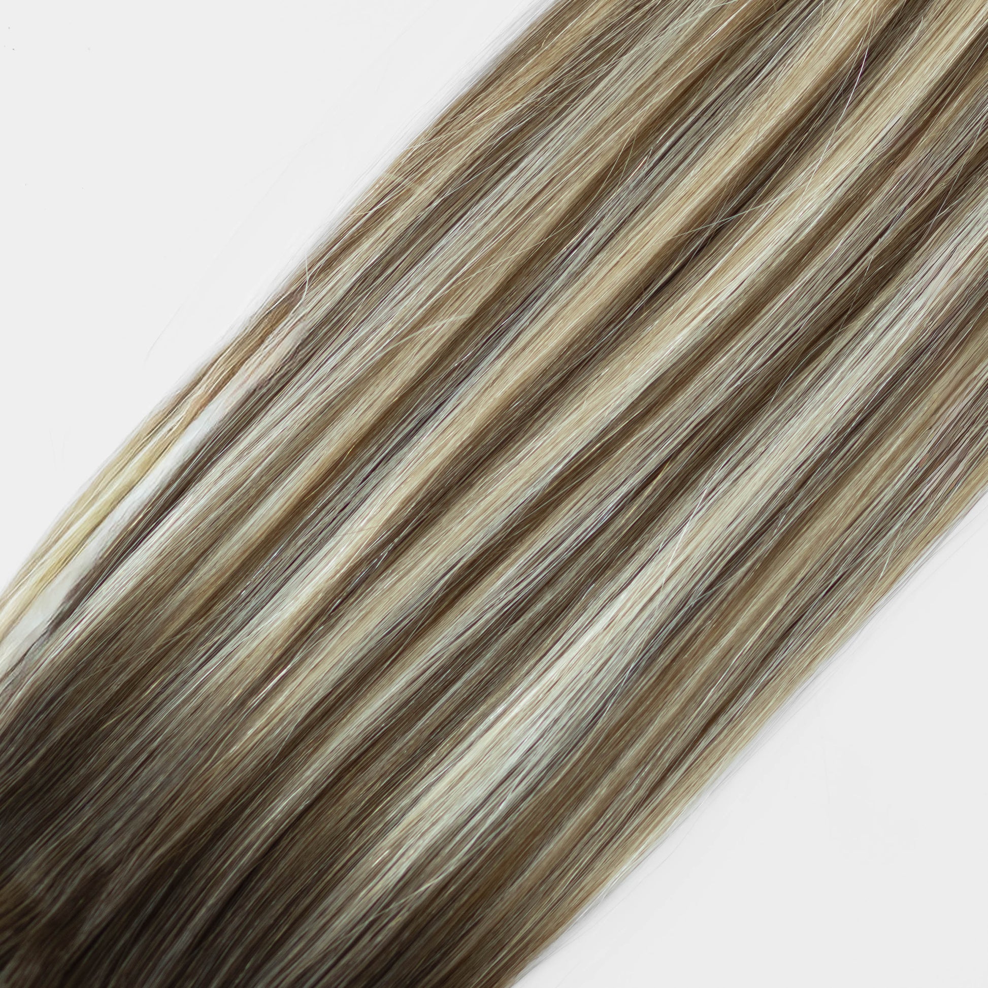 Hair extensions with brown and blonde color on a white background