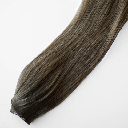 Brown hair extension on a white background