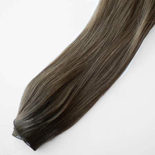 Brown hair extension on a white background