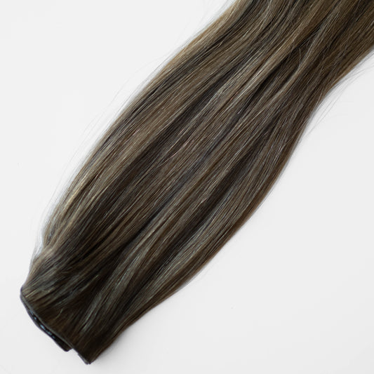 Brown hair extension on a white background