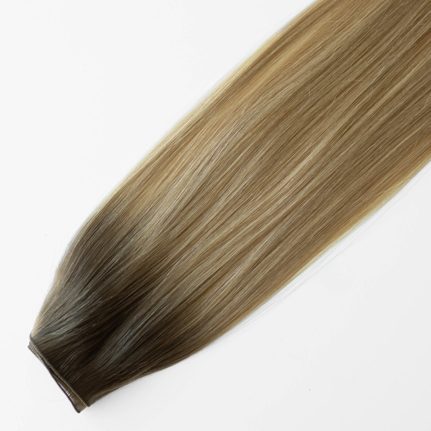 Blonde and brown hair extension on a white background