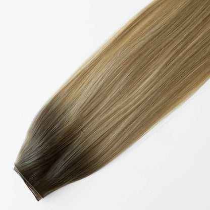 Blonde and brown hair extension on a white background
