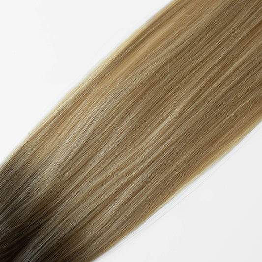 Blonde hair extensions on a white background
