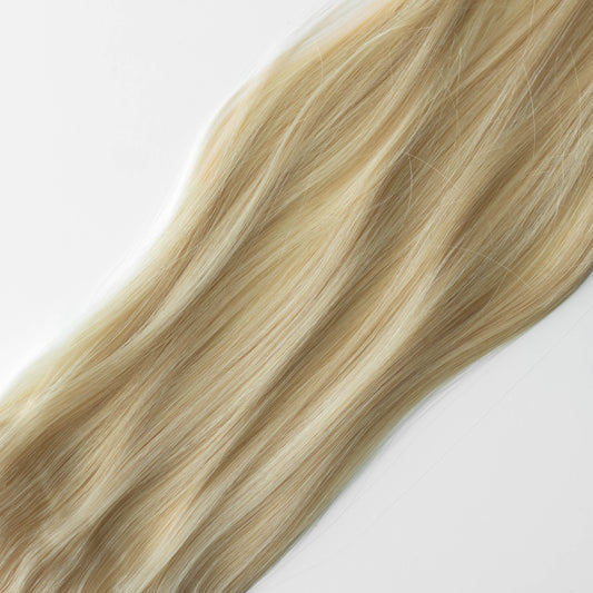 Blonde hair extensions on a white background