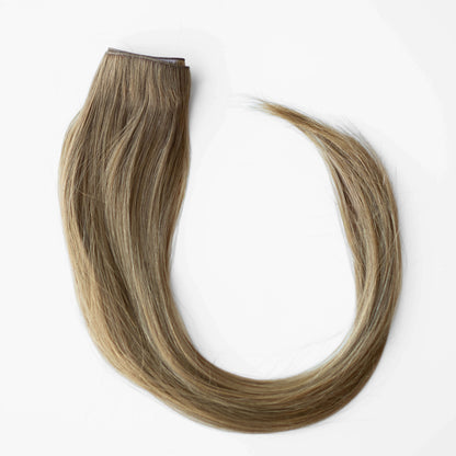 Blonde hair extensions on a white background