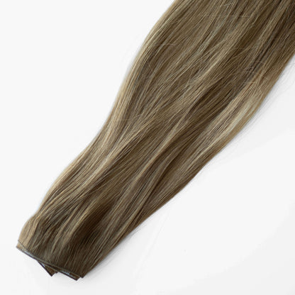 Brown hair extension on a white background