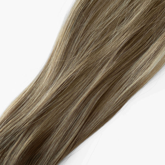 Blonde hair extensions on a white background